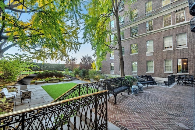 view of property's community featuring a patio area and outdoor lounge area