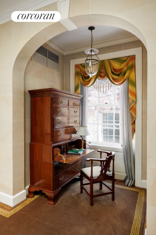 sitting room featuring crown molding