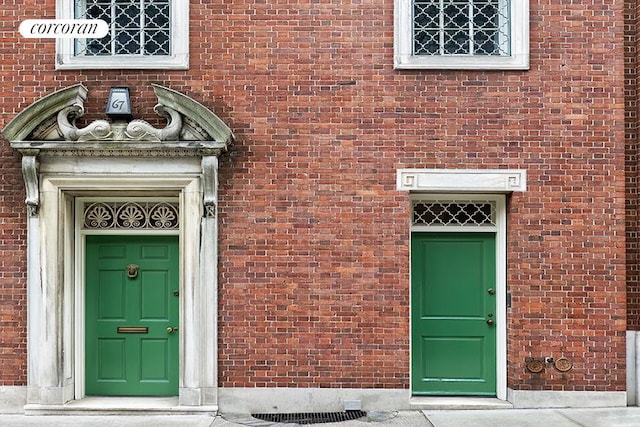 property entrance with brick siding