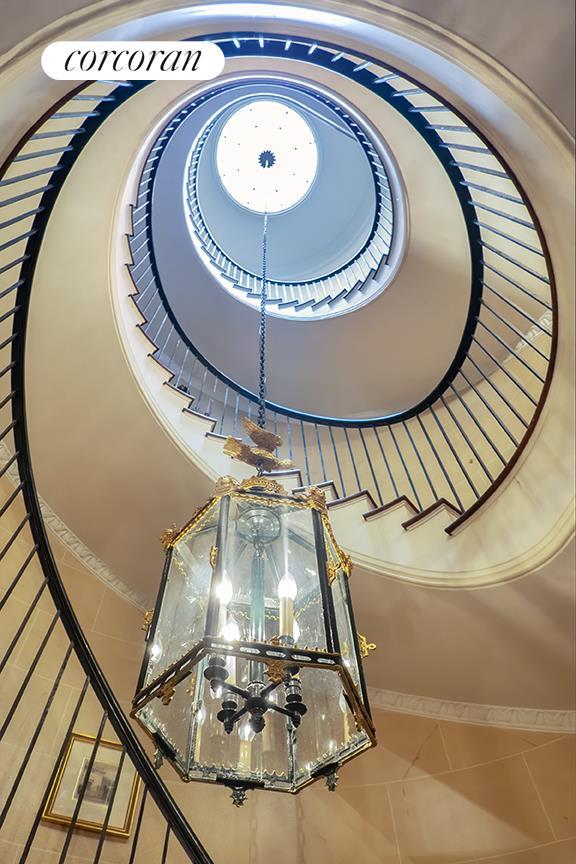 67 E 93rd St, New York City, NY 10128 - staircase with tile patterned flooring and an inviting chandelier