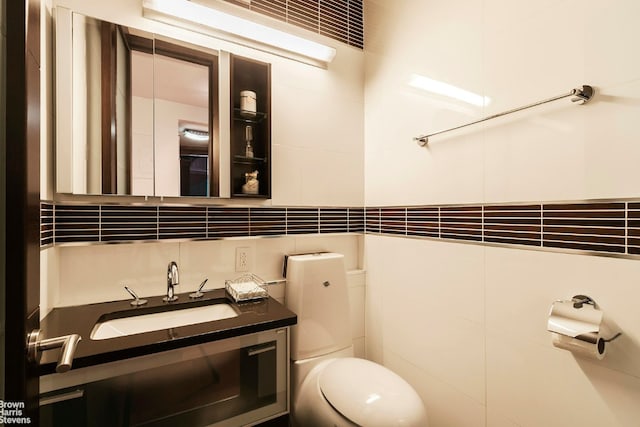 bathroom with tasteful backsplash, vanity, and toilet