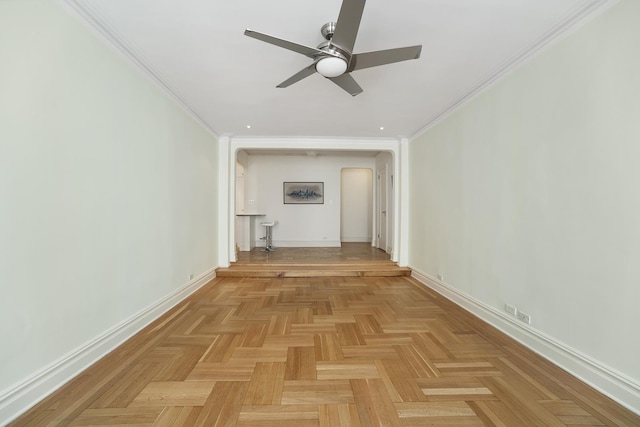 interior space featuring ornamental molding, baseboards, and a ceiling fan