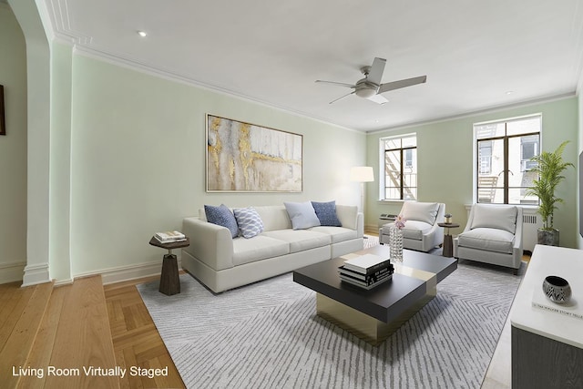 living room with ornamental molding, radiator heating unit, ceiling fan, and baseboards