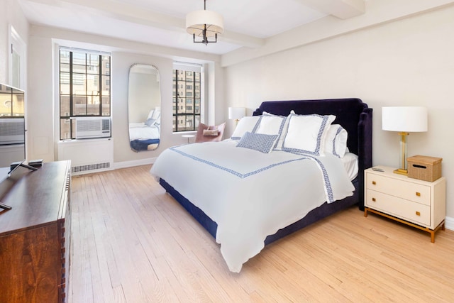 bedroom with beamed ceiling, wood-type flooring, and cooling unit