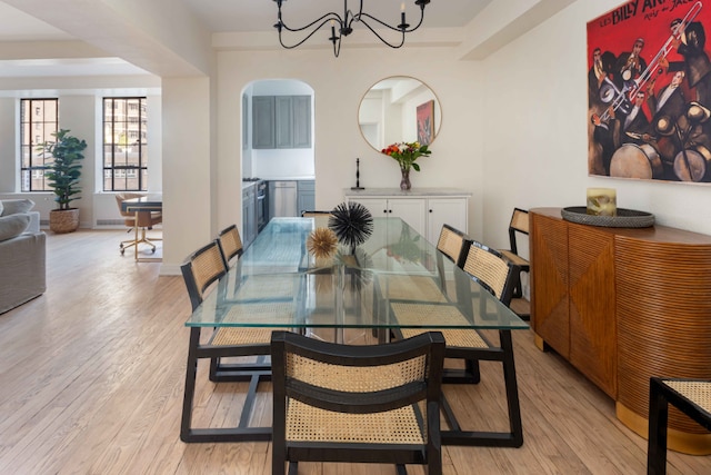 dining room with light wood-type flooring and a chandelier