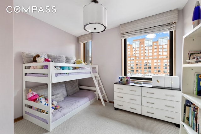 bedroom featuring carpet floors and baseboards