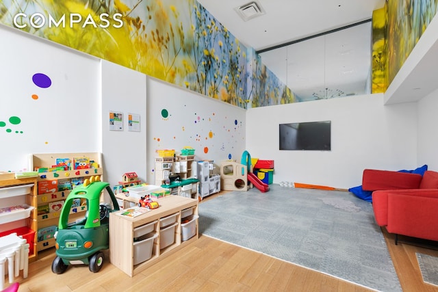 recreation room with visible vents and wood finished floors