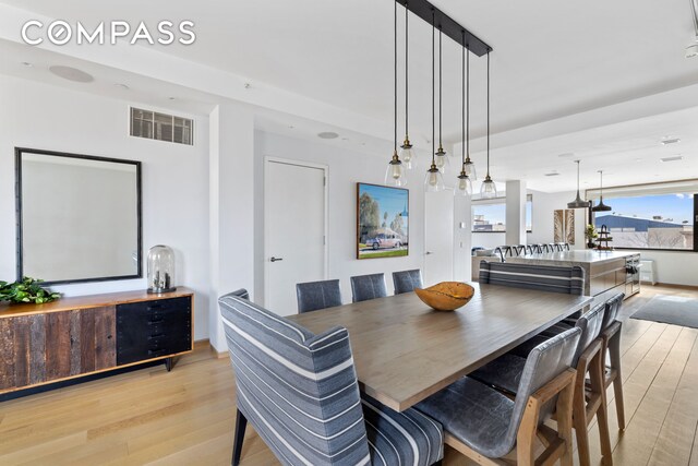 dining room featuring visible vents and light wood finished floors