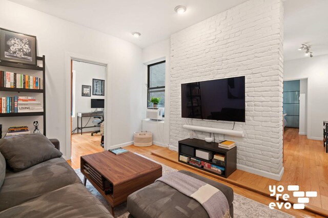 living room featuring track lighting and light hardwood / wood-style flooring