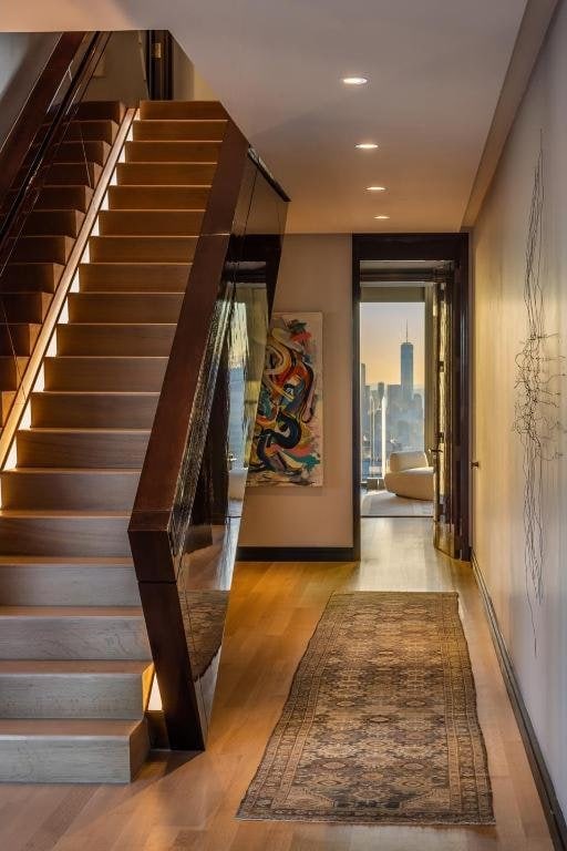 stairs featuring hardwood / wood-style flooring