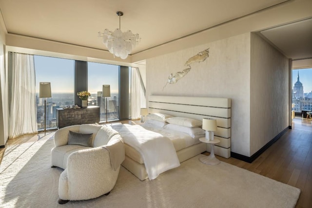 bedroom with light wood-type flooring and an inviting chandelier