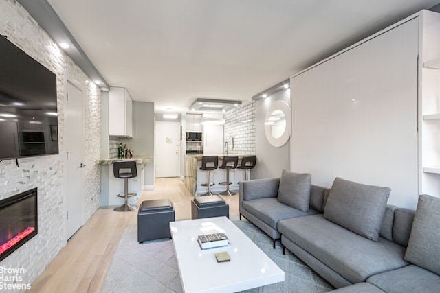 living area featuring a fireplace and light wood-style floors