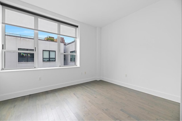 spare room with hardwood / wood-style flooring