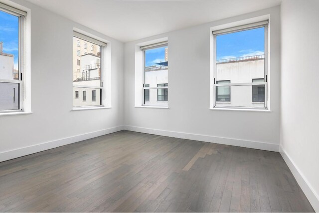 spare room featuring dark hardwood / wood-style floors