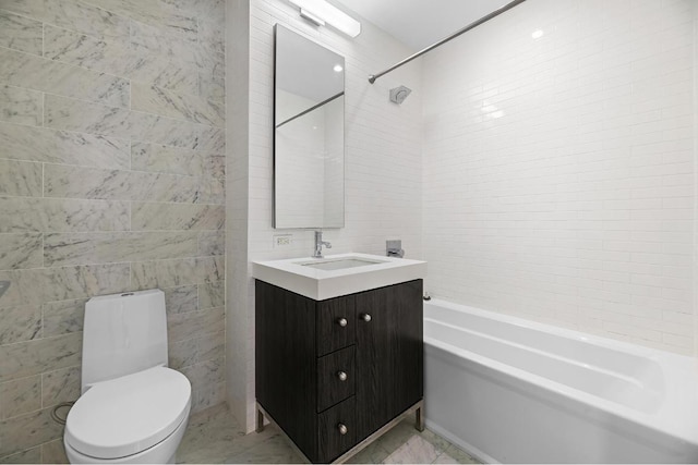 full bathroom with tile walls, vanity, shower / tub combination, and toilet