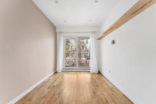 unfurnished room with light wood-type flooring