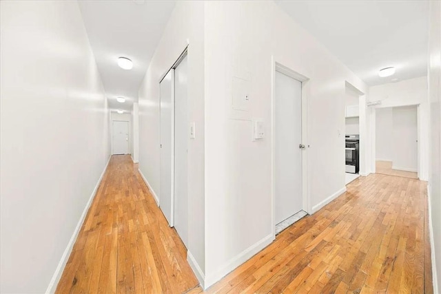 corridor with light wood-type flooring