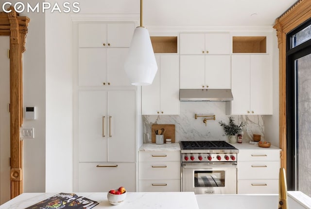 kitchen featuring high end appliances, backsplash, white cabinetry, and light stone countertops