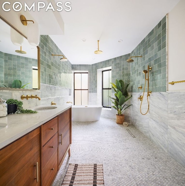 bathroom featuring tile walls, vanity, and plus walk in shower