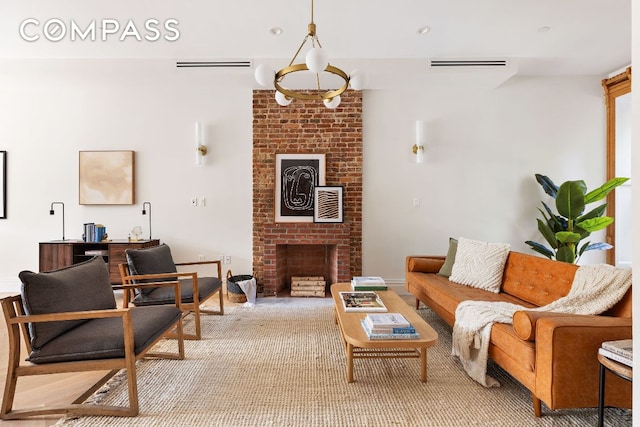 living room featuring carpet floors, a brick fireplace, and visible vents