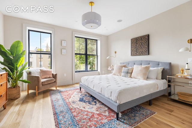 bedroom with baseboards and light wood-style floors