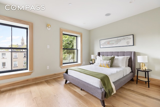 bedroom featuring baseboards and light wood-type flooring