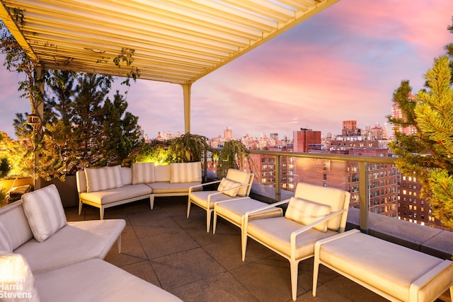 patio terrace at dusk with an outdoor hangout area and a pergola