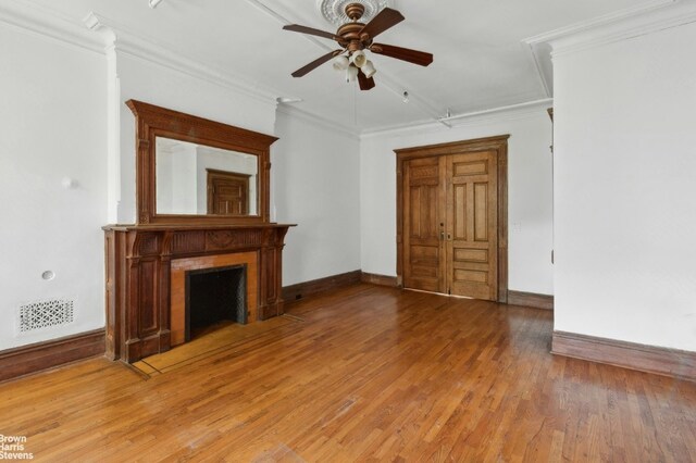 kitchen featuring decorative backsplash, white cabinetry, light hardwood / wood-style flooring, appliances with stainless steel finishes, and radiator heating unit