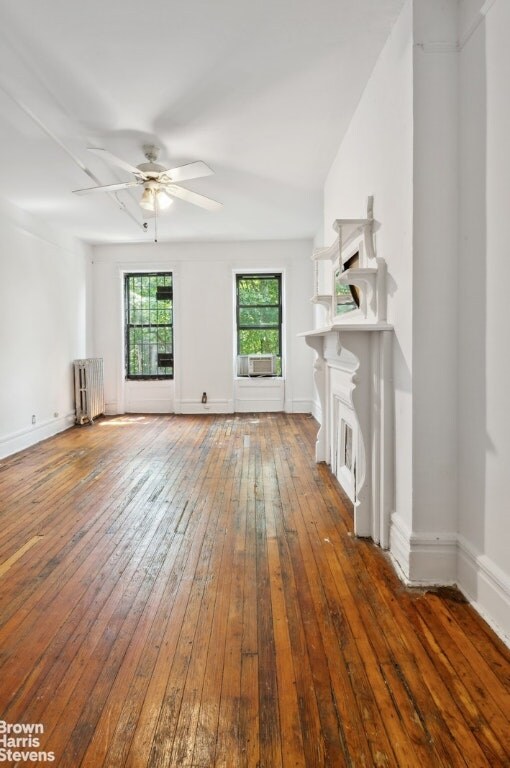 interior details with radiator, parquet floors, and wood walls