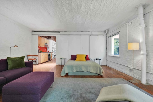 bedroom featuring a textured ceiling and wood finished floors