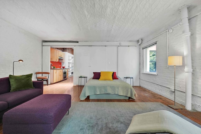 bedroom with a textured ceiling and wood finished floors