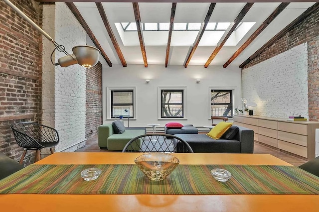 dining space featuring beamed ceiling, brick wall, a skylight, and high vaulted ceiling