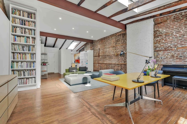 living room with wood-type flooring, lofted ceiling with beams, built in features, and brick wall