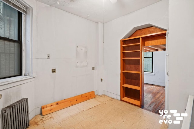 unfurnished room featuring radiator heating unit and tile patterned floors