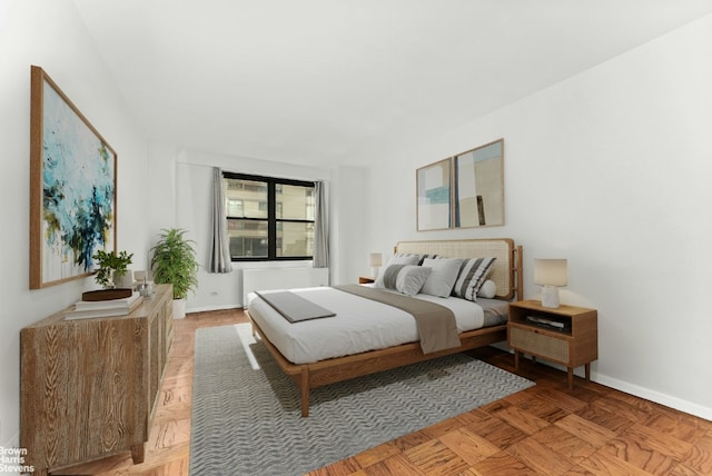 bedroom with light parquet floors