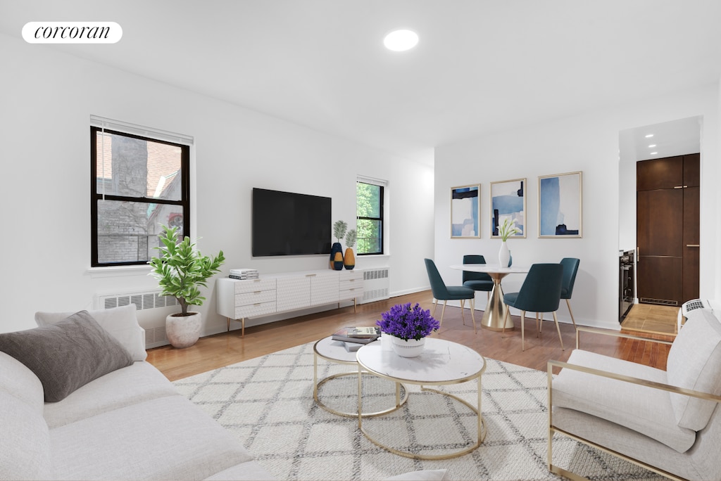 living room with recessed lighting, visible vents, radiator heating unit, and wood finished floors