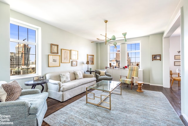 living room featuring dark wood-type flooring and a chandelier