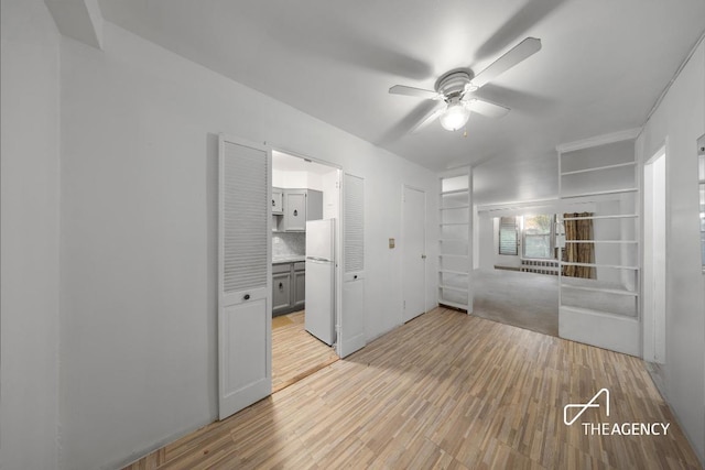 empty room featuring ceiling fan and light wood-type flooring