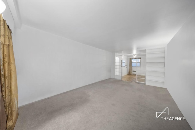 empty room featuring carpet flooring and ceiling fan