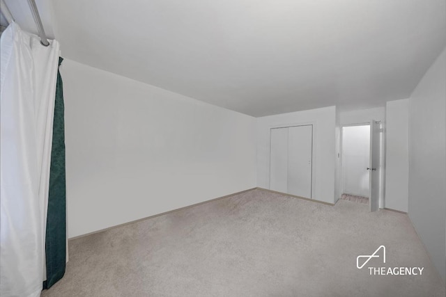 interior space with light colored carpet and a closet