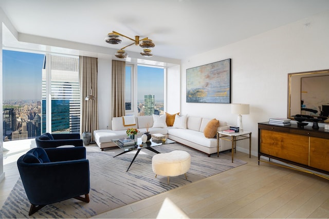 living area featuring a view of city, wood finished floors, and baseboards