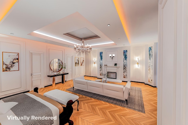 318 W 75th St, New York City, NY 10023 - living area featuring a raised ceiling, a decorative wall, a chandelier, and a glass covered fireplace