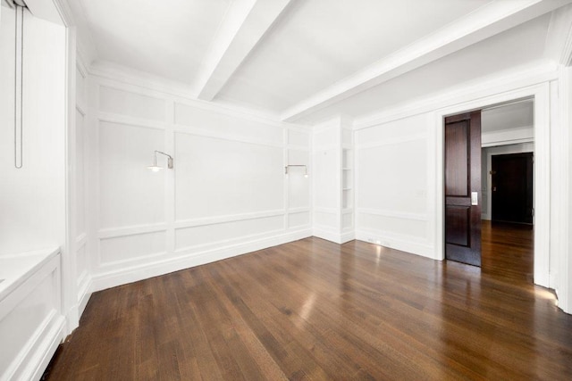 empty room featuring dark wood-type flooring and beamed ceiling