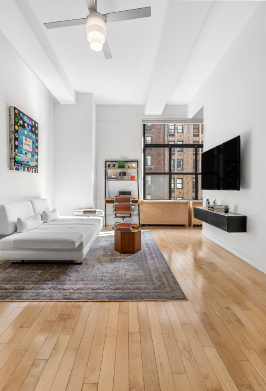 unfurnished living room with hardwood / wood-style floors and ceiling fan