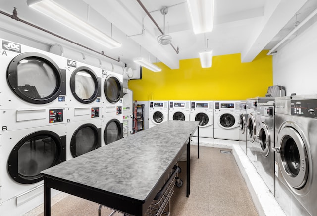 laundry room with stacked washer / drying machine and washer and clothes dryer