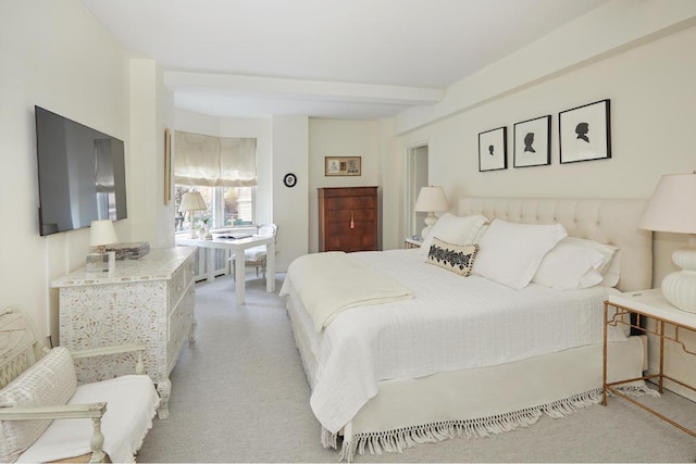 bedroom with light carpet and beamed ceiling