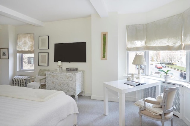 bedroom with light carpet, beam ceiling, and baseboards