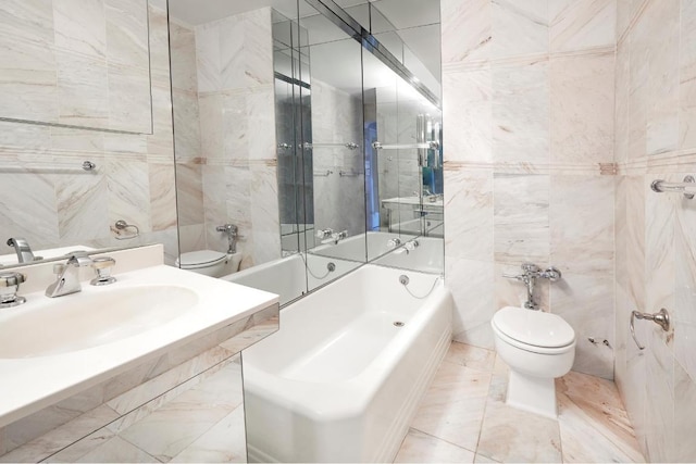 bathroom with a sink, tile walls, and toilet