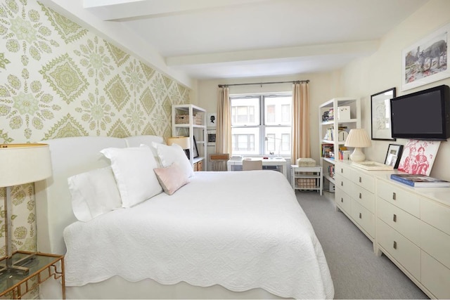 bedroom featuring beamed ceiling, carpet, and wallpapered walls