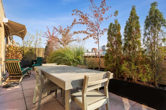 view of patio / terrace featuring outdoor dining space and fence